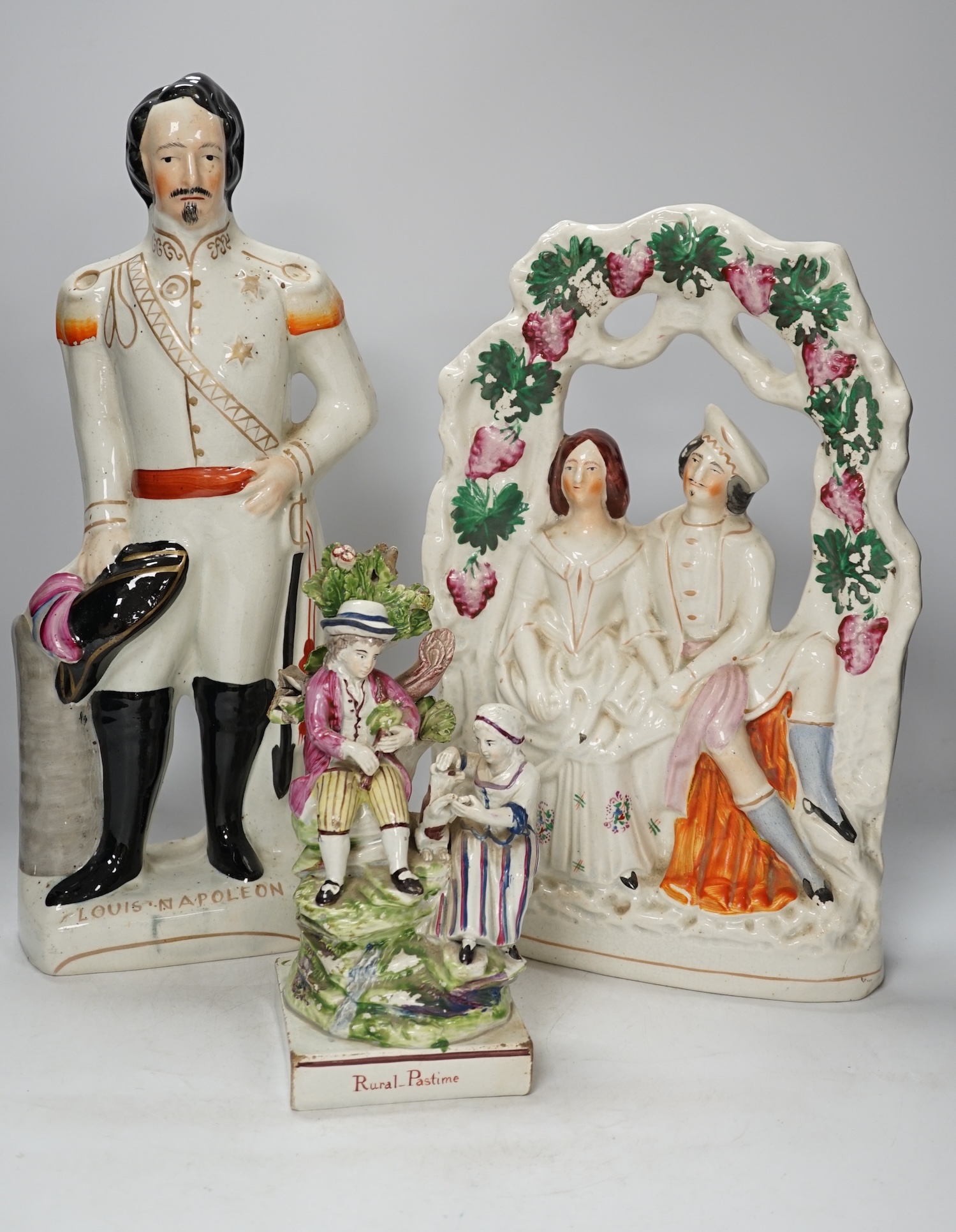 A group of three Staffordshire figures, including Louis Napoleon and Rural Pastime, tallest 41.5cm. Condition - fair
